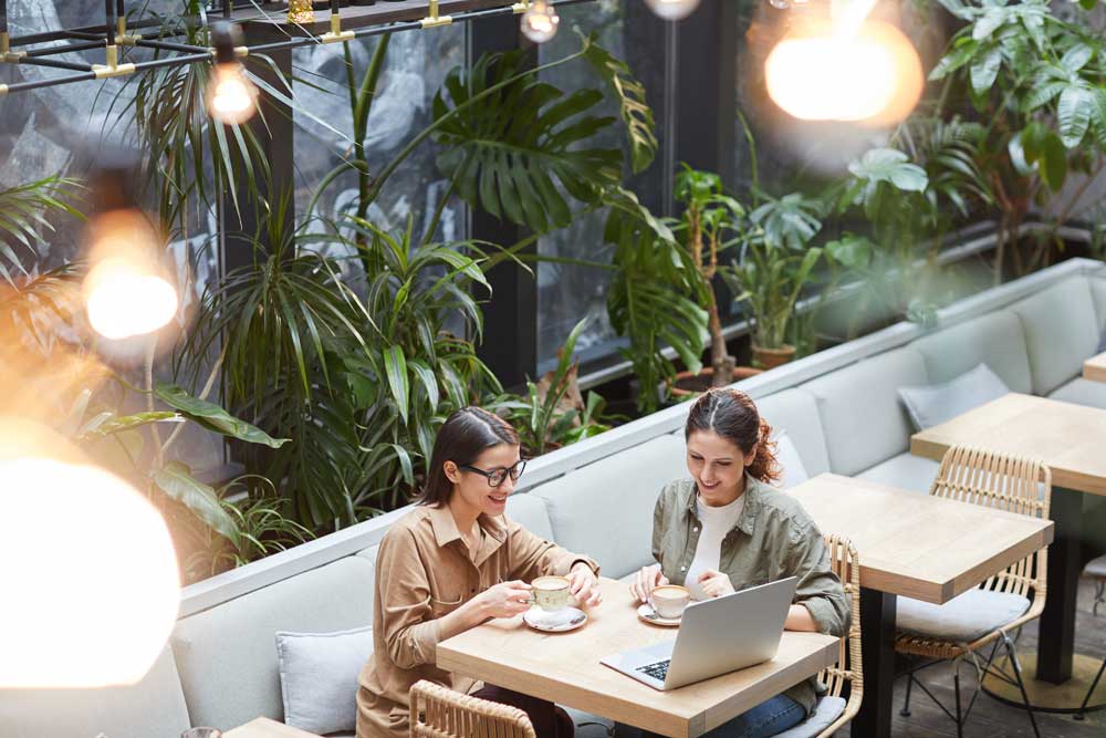 2 people sat with a coffee discussing