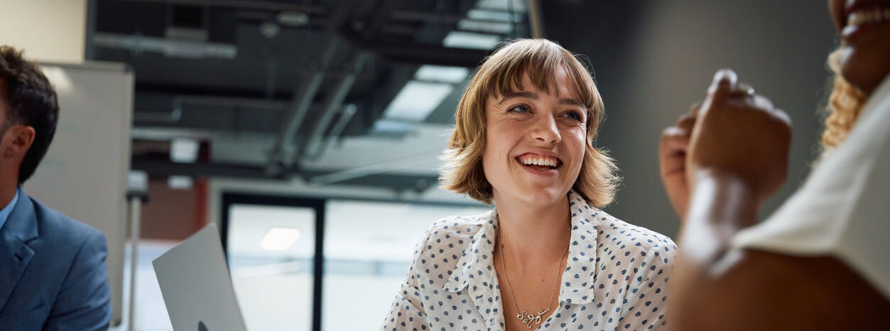 A look angle view of a women smiling at a man whilst in conversation