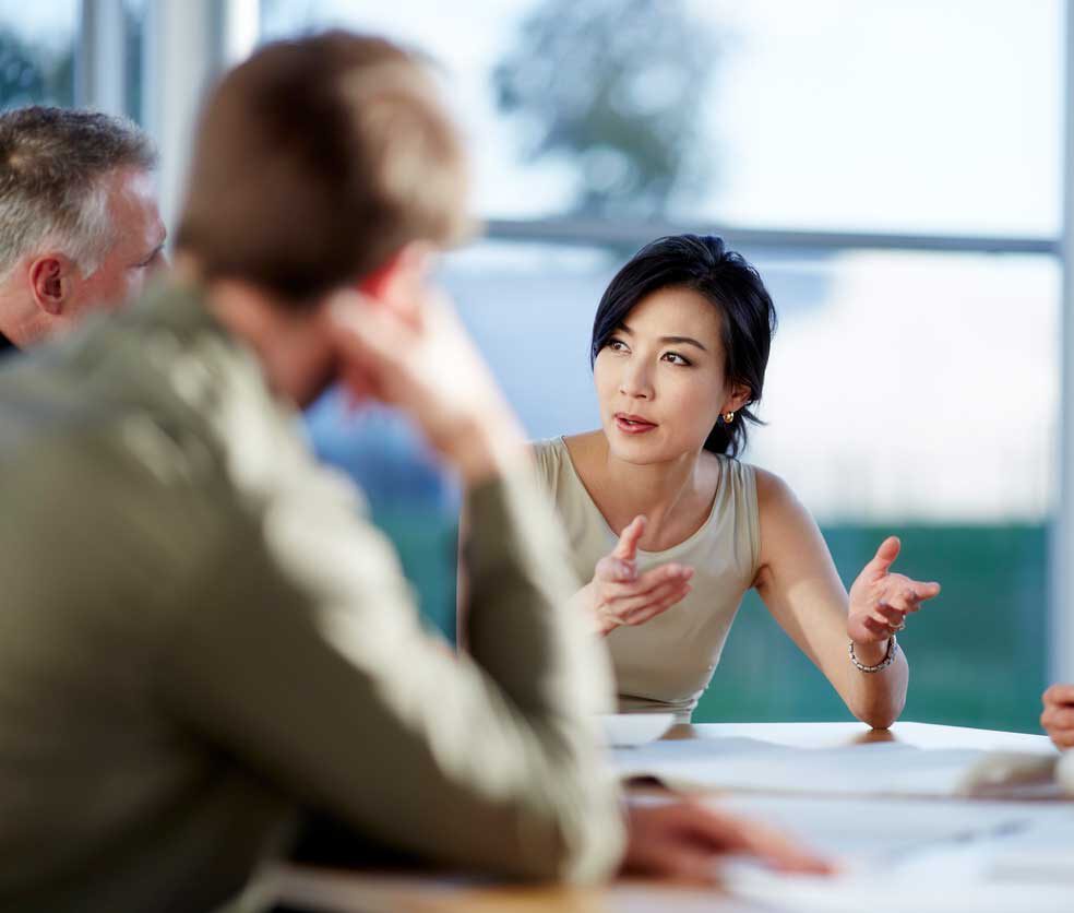 A woman discussing with her peers